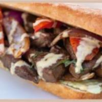 Lomo Saltado Sandwich · Steak and onions sautéed in a fiery wok and marinated in a soy and oyster sauce, lettuce, to...