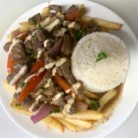Lomo Saltado Platter · Cuts of steak and onions sauteed in a fiery wok and marinated in a soy base dressing. Accomp...