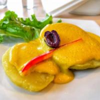 Papa a la Huancaina · Soft sliced boiled potatoes covered with our special Peruvian cheese sauce. Vegetarian.