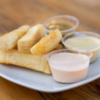 Fried Yucas · Our famous fried yucas and your choice of sauce.