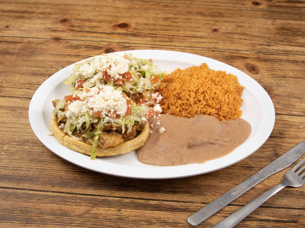 Sopes Plate · 2 thick fried corn tortilla topped with beans, your choice of meat, lettuce, tomato,  queso fresco and a side of rice and beans.