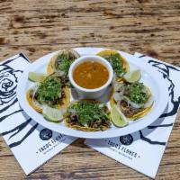 Street Tacos · Five steak tacos on mini corn tortillas with cilantro, grilled onion and a side of charro be...