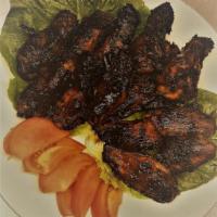 T&G Hennessy Wings · Wings marinated in jerk sauce grilled to perfection top off with our home made Hennessy sauce.