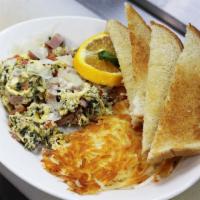 Green Eggs & Ham · Eggs scrambled in a homemade pesto, fresh tomatoes, and diced ham, topped with Parmesan chee...