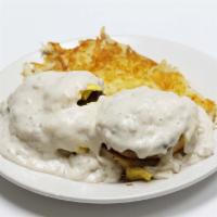 Alan's Country Benedict · Biscuits cut in 1/2 toppled with sausage patty, scrambled eggs smothered in country gravy.