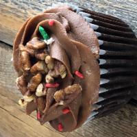 Turtle Cupcake · Chocolate cupcake with chocolate buttercream frosting, homemade caramel, pecans, and sprinkles