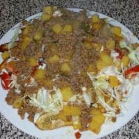 Carne Molida Con Tajadas (Ground Beef) · Ground beef with fried green bananas, grated cabbage, pico de gallo and house specialty sauc...