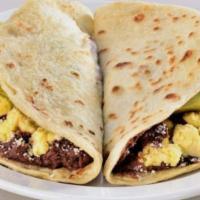 Baleada con Carne Asada (Baleada with grilled meat) · Flour tortilla, mashed beans, sour cream, grated cheese, avocado slice with grilled meat (be...