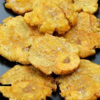 Tostones (Fried green Platains) · Flat fried green plantains
Tostones