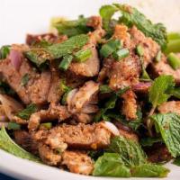 Nam Tok  · (SPICY) (Grilled Beef Salad) Grilled steak marinated in spiciness, scallions, red onions, to...