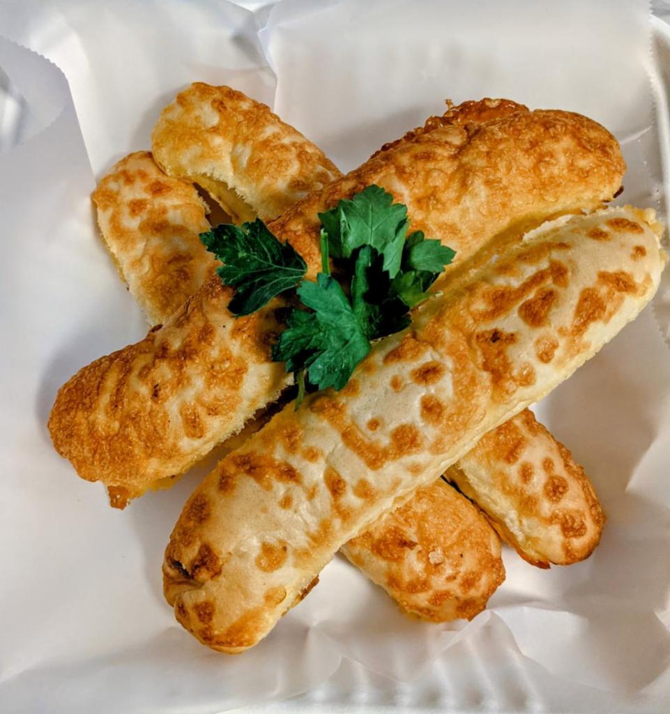 Super Cheesy Breadsticks · Can't have an American/Italian menu without these.... They're everyone's favorite. Fresh breadsticks with the cheese baked right in! Comes with 4, or you can DOUBLE it for just a few bucks more!