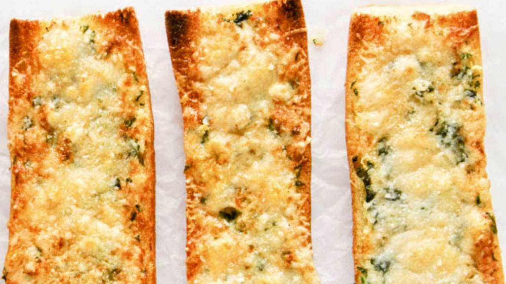 Fresh Baked Garlic/Parmesan Bread · Classic baguette, split in half and smothered in Garlic Butter and Italian Seasoning. Perfect for Two People