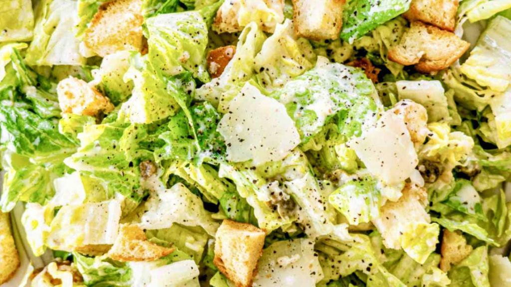 Fresh Caesar Salad · Hearts of Romaine, tossed with parmesan cheese, croutons, and a famous Caesar Dressing. 
Made Fresh to order! Add Protein and Extras if ya'd Like. Perfect for 2 people. Double it for just $4 more!