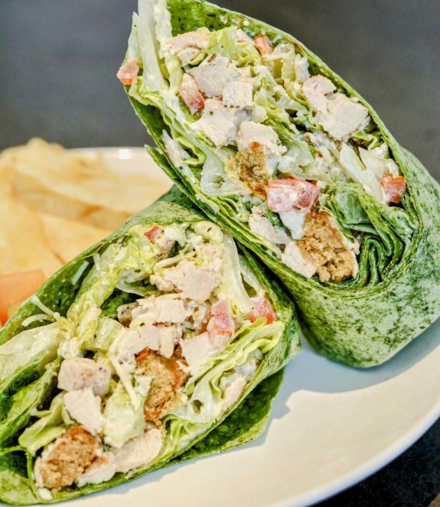Grilled Chicken Caesar Wrap · The perfect blend of salad and sandwich. Our Classic Caesar Salad with Grilled Chicken added, topped with crispy onion straws for a lil added crunch, then wrapped in a Spinach Wrap (while supplies last). Delicious and easy on the waistline. Customize it with goodies for a way to shake up your routine. Served with a scoop of our Famous Mac and Cheese