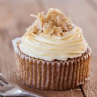 Vegan Spelt Irish Oatmeal Jumbo Cupcake · Oatmeal spiced cake topped with coconut almonds and iced in a vegan white frosting.