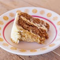 Vegan Spelt Irish Oatmeal Cake Slice · Moist oatmeal spice cake iced in vegan white with almond coconut brown sugar topping.