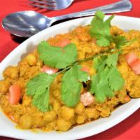 CHANA MASALA · Chickpeas cooked w/ tomatoes, onions and spices. Served with rice.