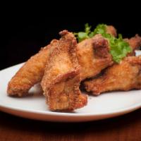 Chicken Wings with Crispy garlic · Deep fried chicken wings, palm sugar, fried garlic served with pickled carrot and daikon.