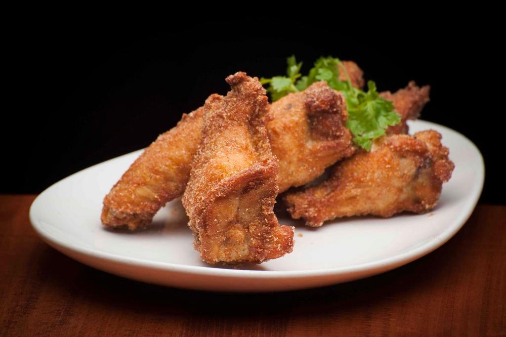 Chicken Wings with Crispy garlic · Deep fried chicken wings, palm sugar, fried garlic served with pickled carrot and daikon.