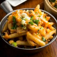 Kimchee Fries · Sriracha mayo, scallions, and sesame seeds topped with spicy pickled cabbage