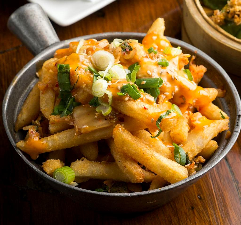 Kimchee Fries · Sriracha mayo, scallions, and sesame seeds topped with spicy pickled cabbage