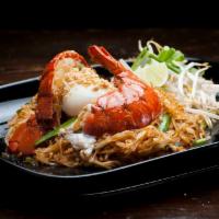 Lobster Pad Thai · Stir fried thin rice noodles, whole lobster, bean sprouts, chives and peanut top with poache...