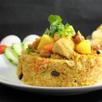 24. Pineapple Fried Rice · Stir-fried jasmine rice with yellow curry powder, pineapple, carrot, onion, raisin, cashew n...
