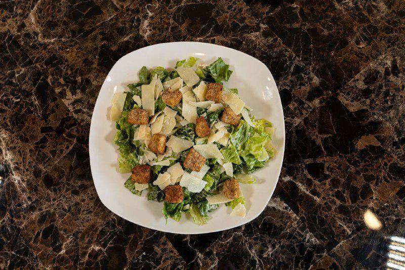 Caesar Salad · Lettuce, croutons, parmesan cheese tossed with caesar dressing. Add chicken for an additional charge.