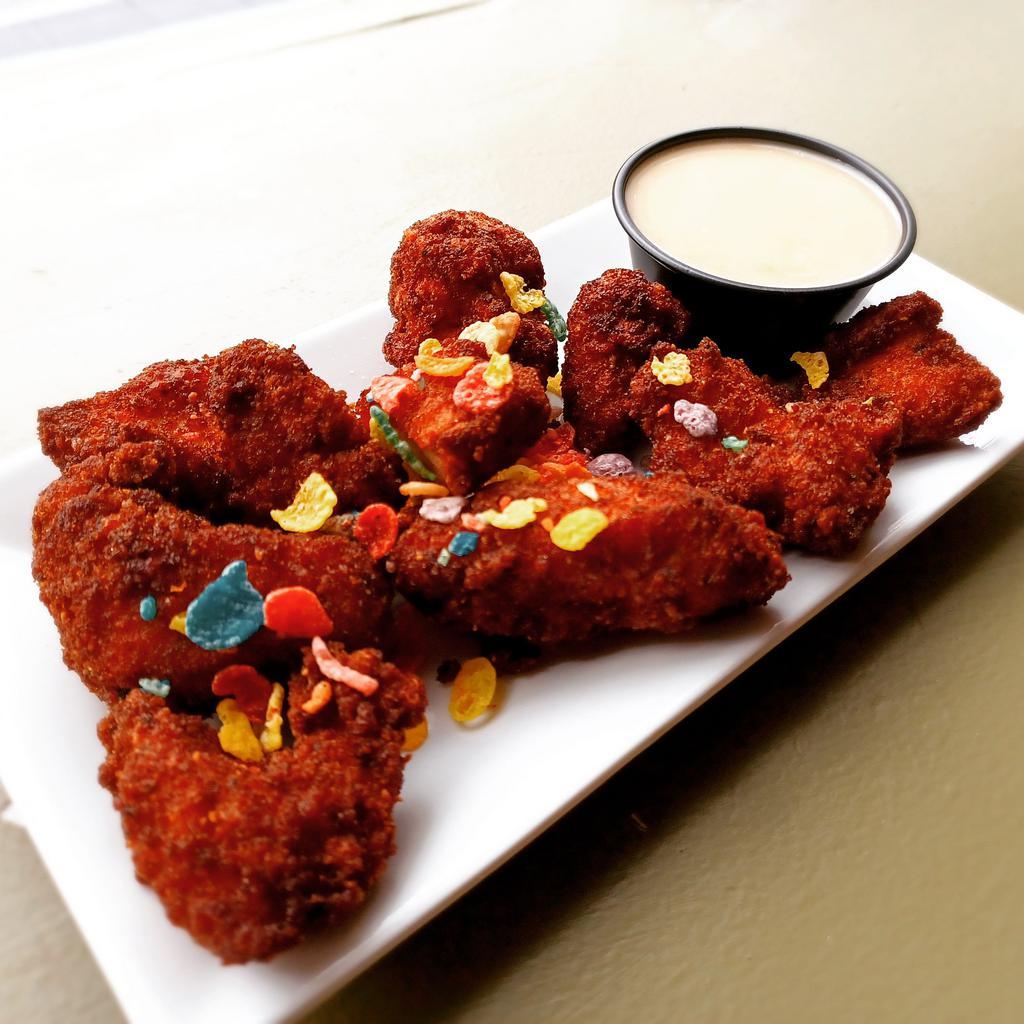 Bedrock Bites · Hand-cut chicken breast nuggets breaded with gluten-free breadcrumbs and Fruity Pebbles cereal, served with choice of sauce. Gluten free