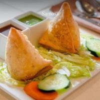 2 Pieces Potatoes Samosa  · Cone pastry stuffed with green peas, potatoes, and fresh coriander leaves. Served with tamar...