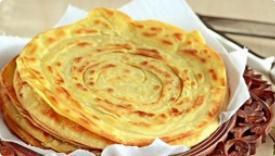 Lachcha Paratha · Whole wheat layered flat bread baked in a clay tandoor oven.