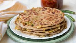 Aloo Paratha · Whole wheat flat bread stuffed with special boiled potatoes and cilantro baked in a clay tan...