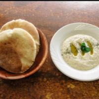 Baba Ghanoush · Grilled eggplants grounded, lemon juice tahini sesame oil and garlic, comes with only 1 pita...