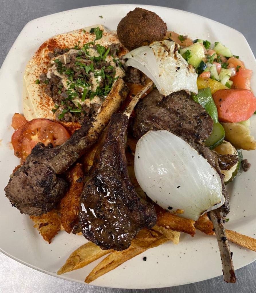Lamb Chops · Marinated in a special seasoning served on a plate with a side salad, hummus, pita bread and choice of rice or fries.
