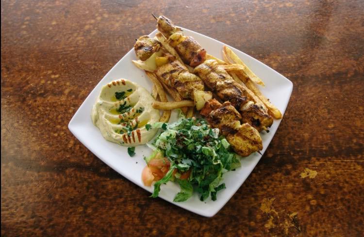 Shish Taouk · Cubed chicken marinated in our blend of spices Then skewered and grilled to perfection, served with Hummus, salad, pita bread and choice of rice or fries.