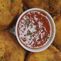 Fried Ravioli · Cheesy ravioli ,breaded and deep fried to a crisp golden brown. Served with our delicious sa...