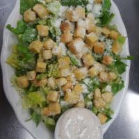 Caesar Salad · Crisp romaine lettuce topped with tasty croutons, grated cheese, and Caesar dressing on the ...