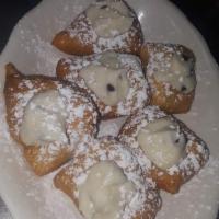 Sweet Treat · 1/2 dozen. Zeppoli with cannoli cream in the middle sprinkled with powdered sugar.