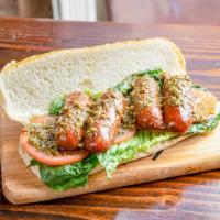 Choripan Sandwich · Grilled Peruvian style sausage on a crispy bread, lettuce, and tomatoes with homemade chimic...