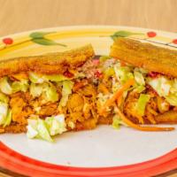 Patacón · A delicious sandwich made with two thin crispy slices of fried free plantain instead of brea...