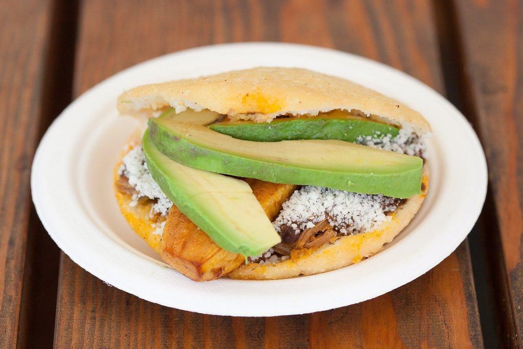 Pabellón Arepa · Stuffed with shredded beef, black beans, cotija cheese, avocado, and plantain.