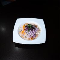Ceviche de Pescado · Fresh fish marinated in lime and Peruvian spicy red pepper. Served with sweet potatoes, swee...