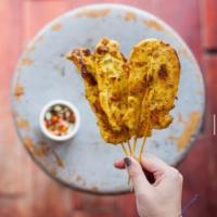 A6.	Satay · (4) chicken skewers, marinated and grilled. Served with peanut sauce.