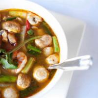 A11.	Tom Yum · Lemongrass based soup with cilantro, kaffir lime leaves, mushrooms, onion, tomato, and your ...