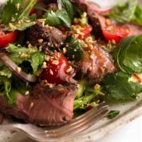 Thai Beef Salad · Grilled beef with cilantro, cucumber, mixed greens, lemongrass, mint, onion, ground toasted ...