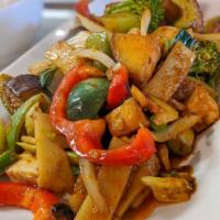 37.	Pad Phet · Thai eggplants stir-fried with basil leaves in red curry sauce with bamboo shoots, bell pepp...