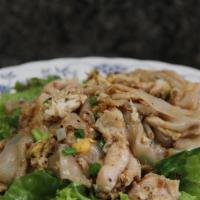65.	Pad Gai · Stir-fried chicken or your choice of protein with wide rice noodles in our house garlic and ...