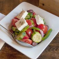 Elliniki Salad · Classic Greek salad with tomatoes, cucumbers, onions, romaine lettuce, olives and feta cheese.
