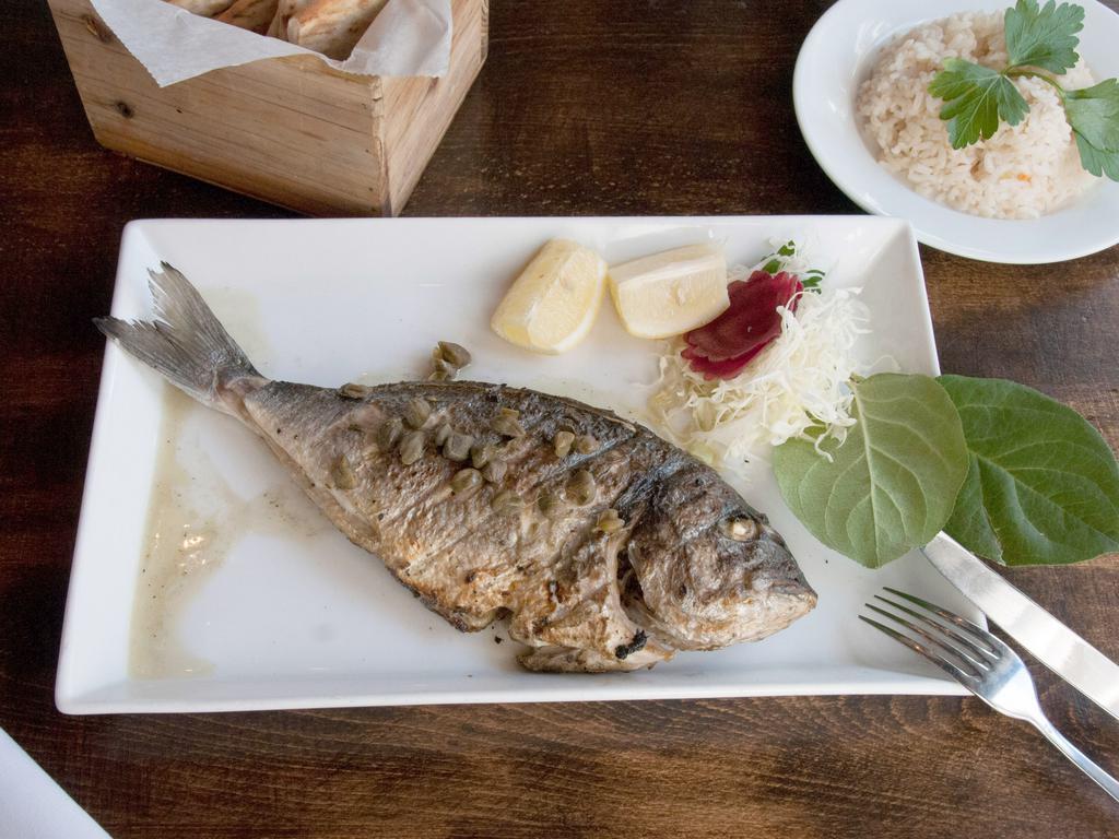 Tsipoura · Porgy fish with a mild, light flavor. Freshly caught whole fish charcoal grilled and drizzled with our own homemade olive oil and lemon.