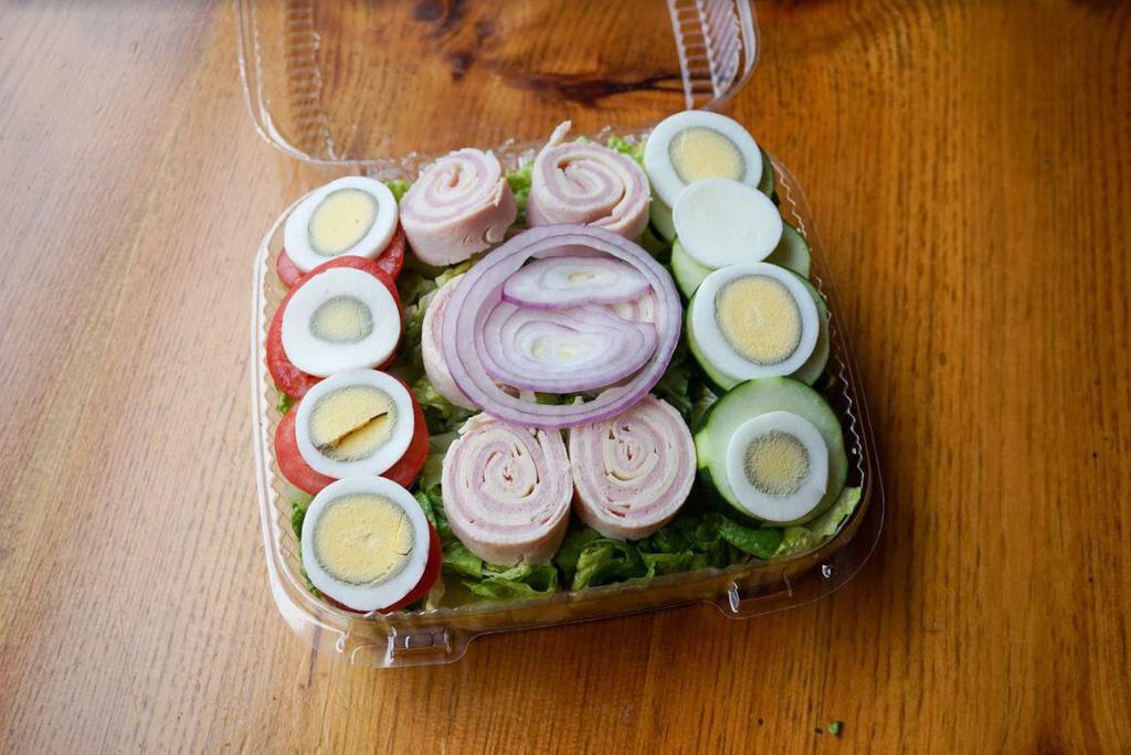Chef Salad · Rolled turkey, ham and Swiss served over mixed greens with hard-boiled eggs, cucumbers, tomatoes, onions and carrots.